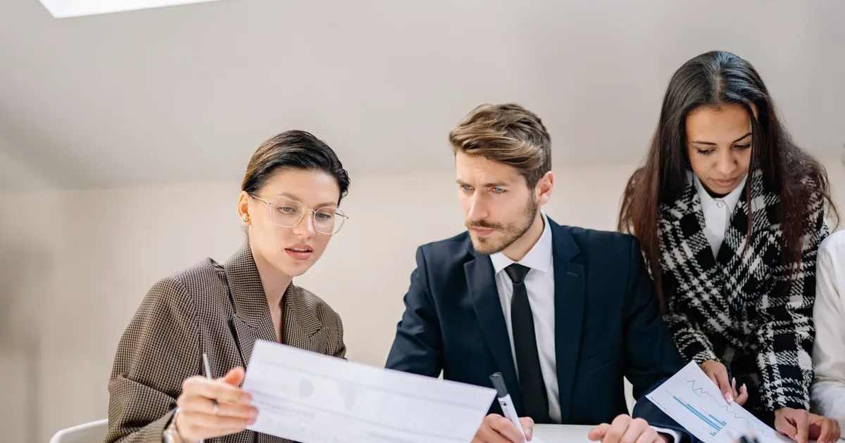 Employer team reviewing a prescription drug plan notice together at an office desk