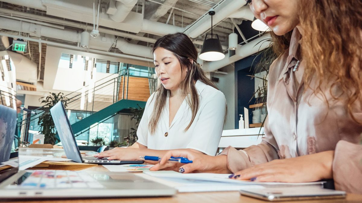 A diverse team of professionals discussing employee health benefits in a modern office