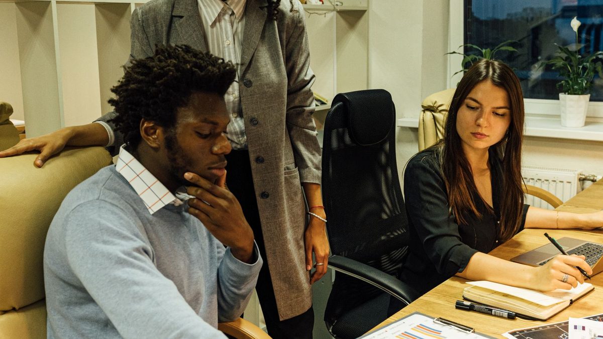 A diverse team of professionals discussing employee health benefits in a modern office