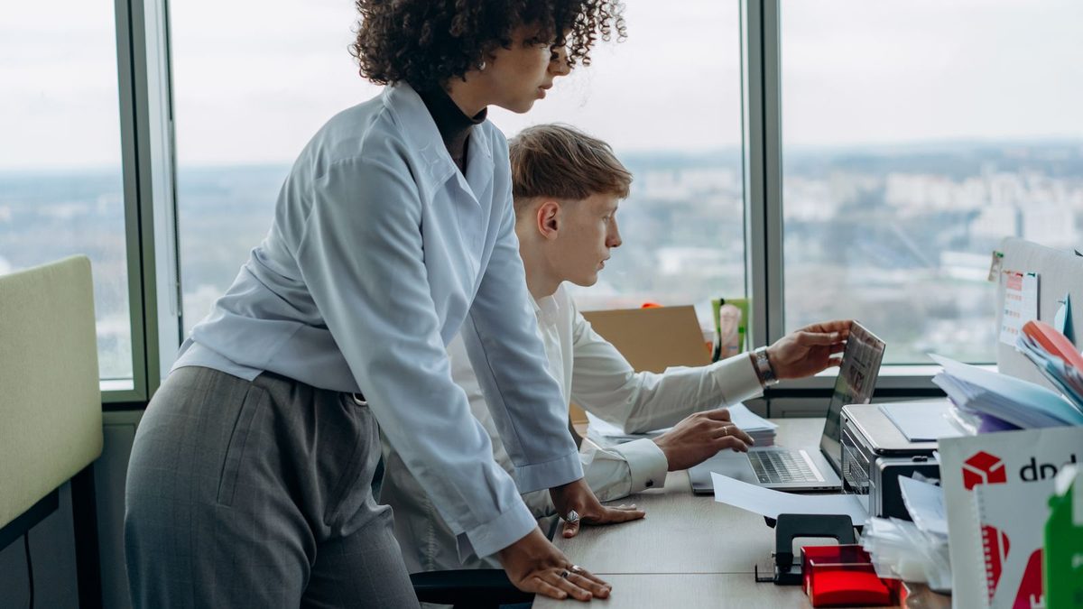 A diverse team of professionals discussing employee health benefits in a modern office