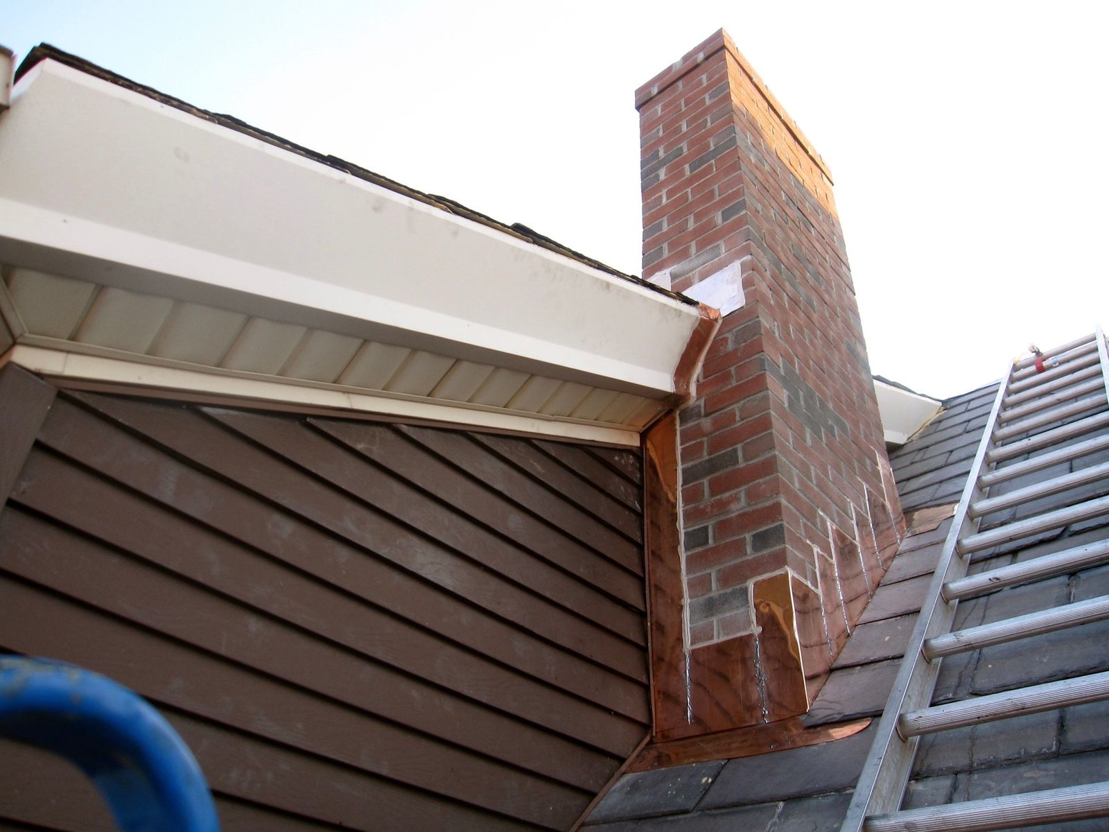 Brick chimney with newly installed copper flashing