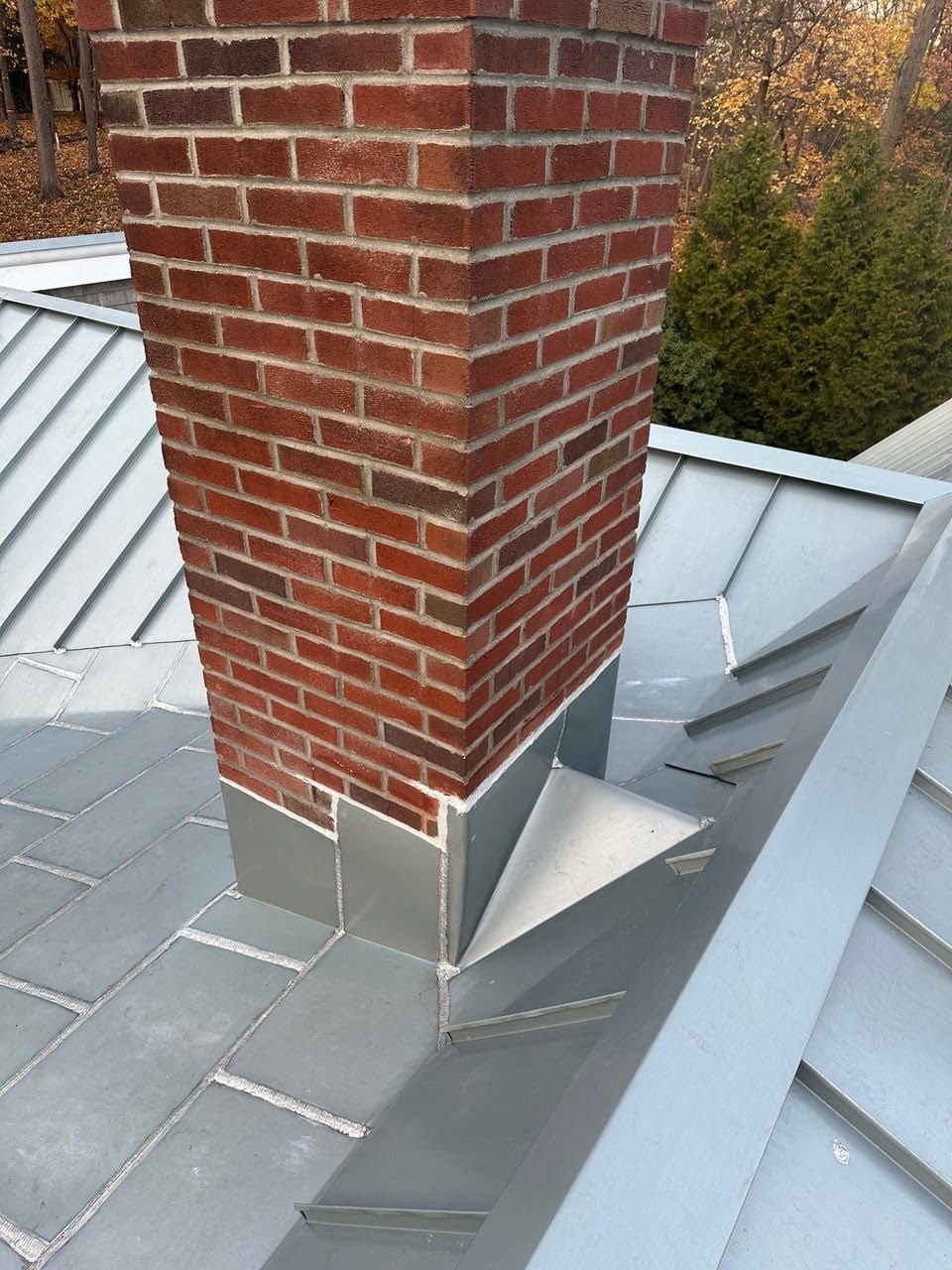 Brick chimney with detail of slate roof