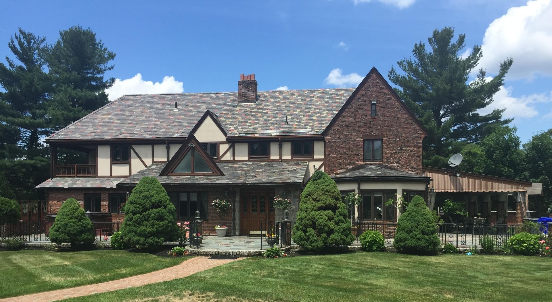 Tudor home in Newton with restored multi-color slate roof