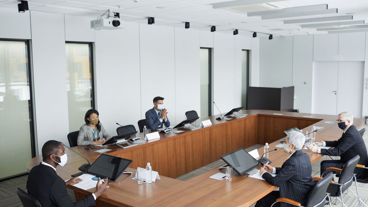 A diverse team of professionals discussing employee health benefits in a modern office