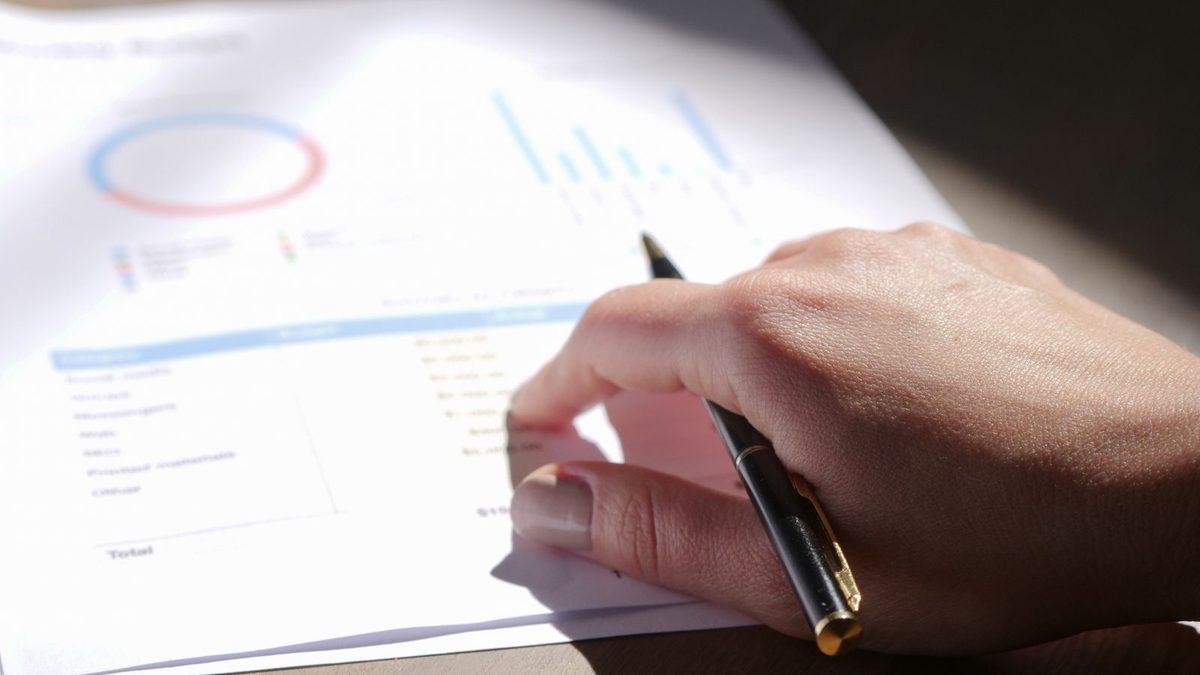 A professional analyzing health plan cost and claims data with charts
