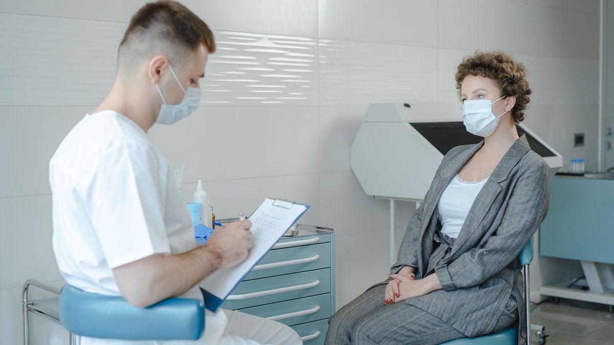 A doctor consulting with a patient in a clinical setting