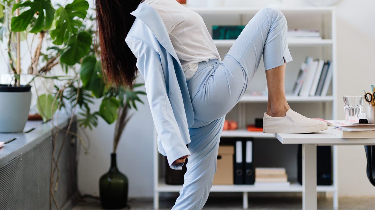 An employee practicing wellness and mindfulness in a bright office
