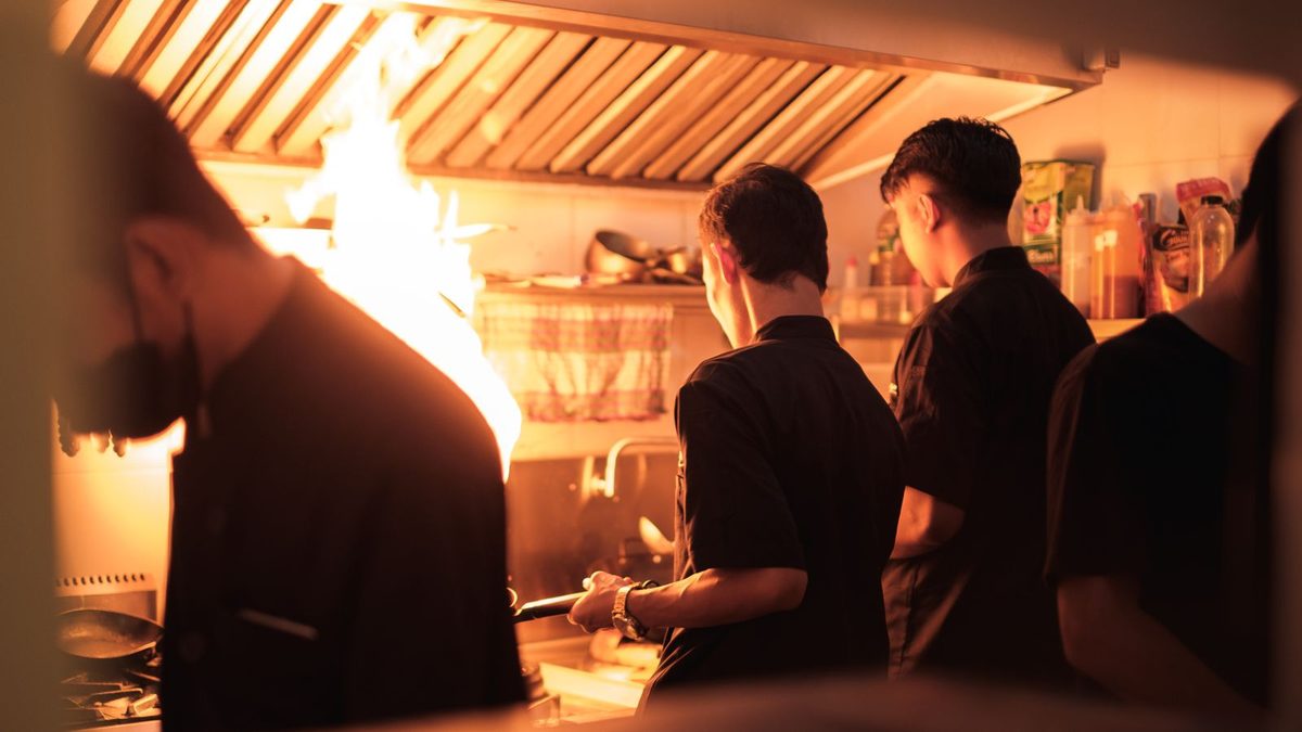 Restaurant and hospitality staff working together in a busy kitchen