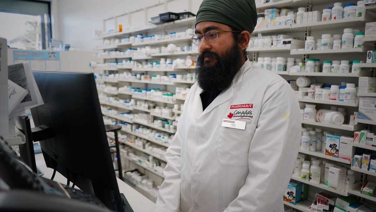 A pharmacist managing prescription medications in a pharmacy