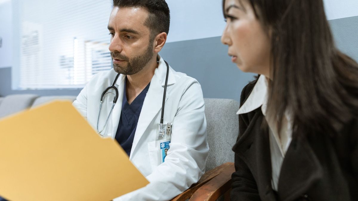 A doctor consulting with a patient in a clinical setting