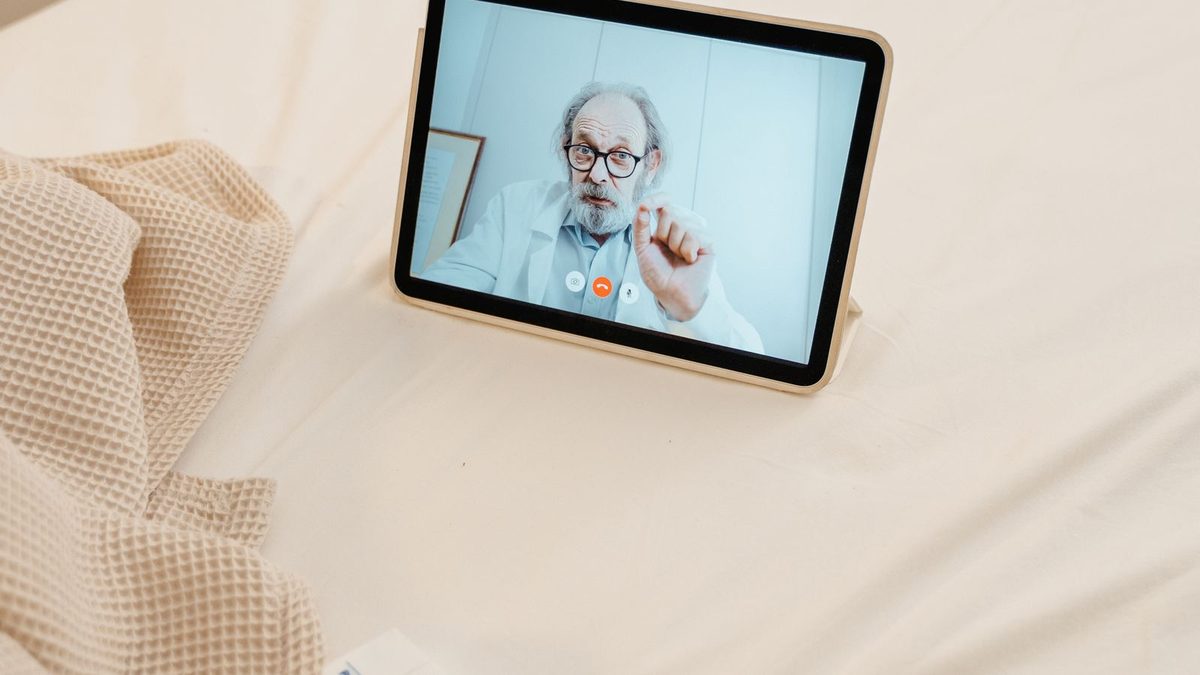 A doctor conducting a telemedicine video consultation with a patient