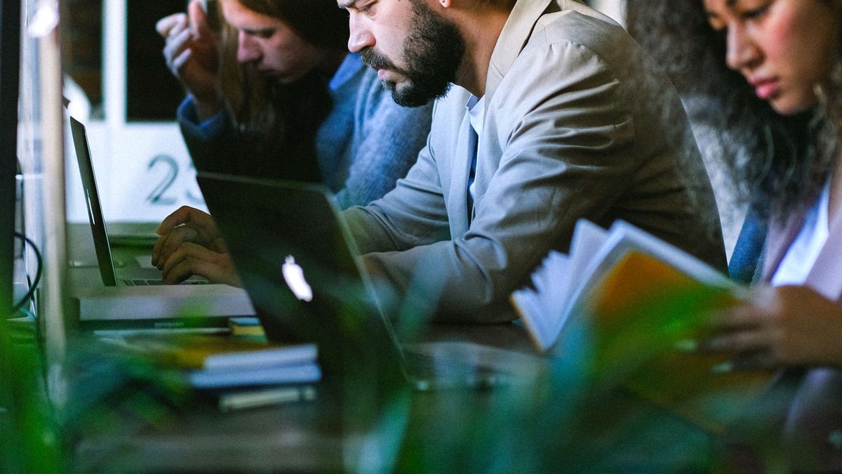 A diverse team of professionals discussing employee health benefits in a modern office