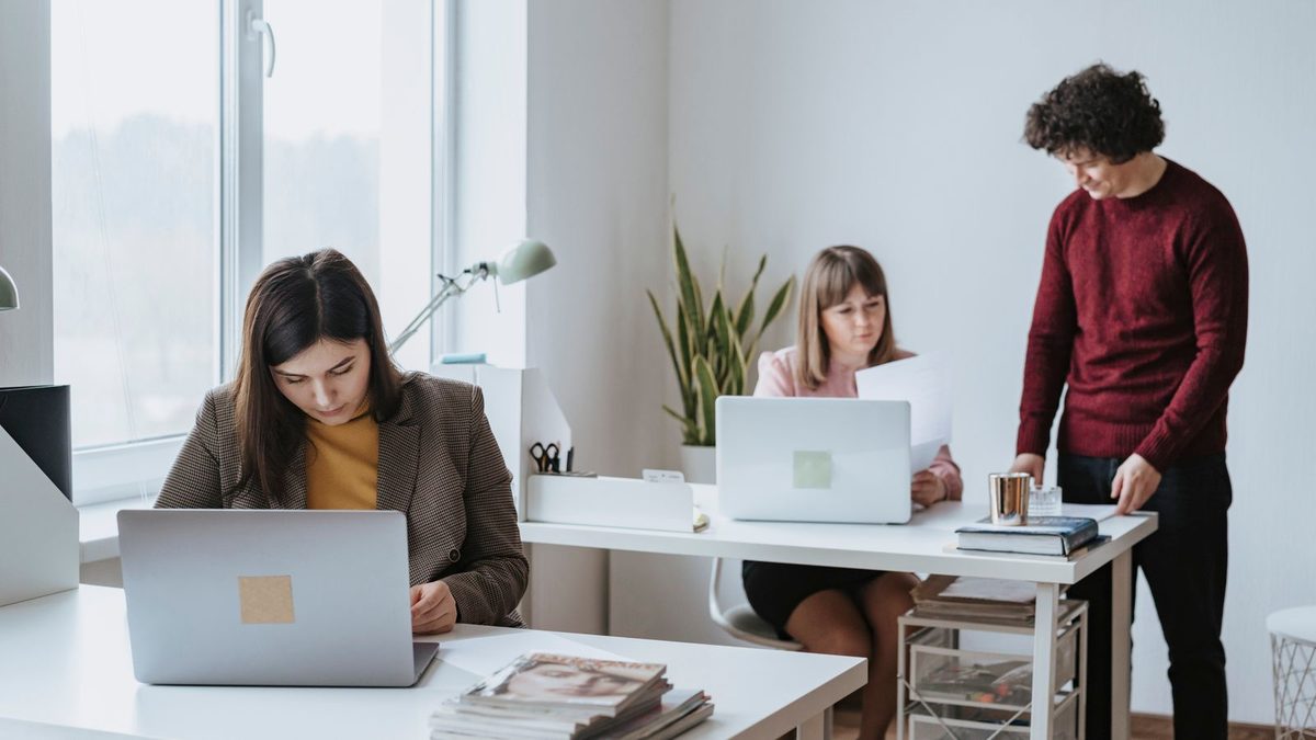 A diverse team of professionals discussing employee health benefits in a modern office