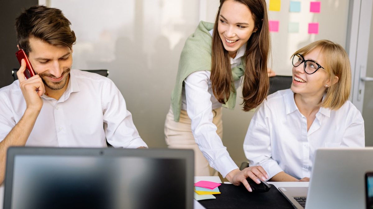A diverse team of professionals discussing employee health benefits in a modern office