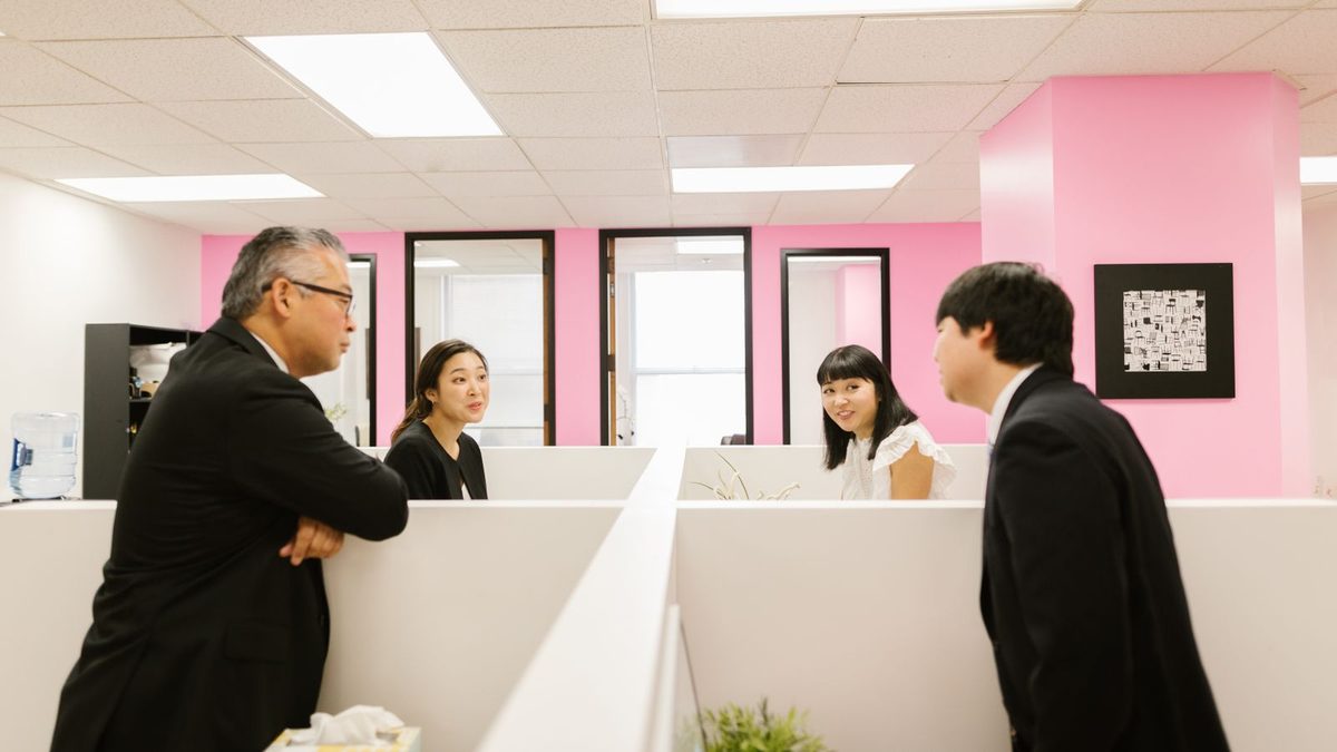A diverse team of professionals discussing employee health benefits in a modern office