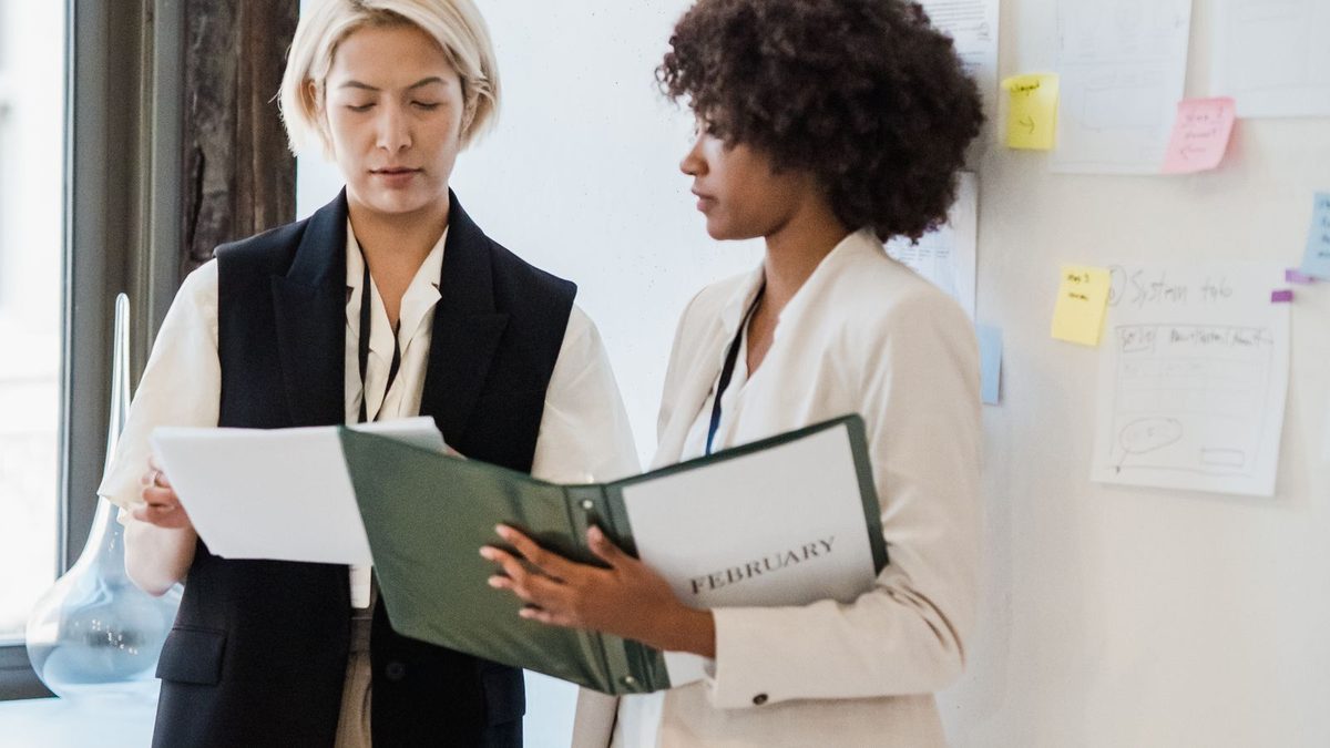 A diverse team of professionals discussing employee health benefits in a modern office