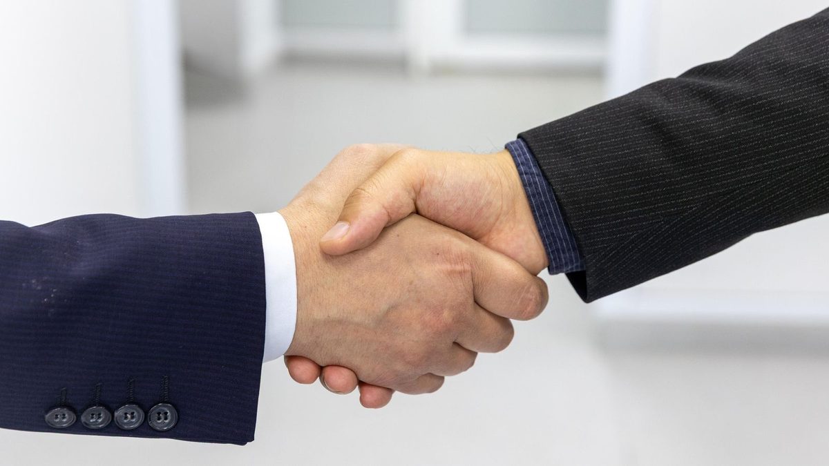 A diverse team of professionals discussing employee health benefits in a modern office