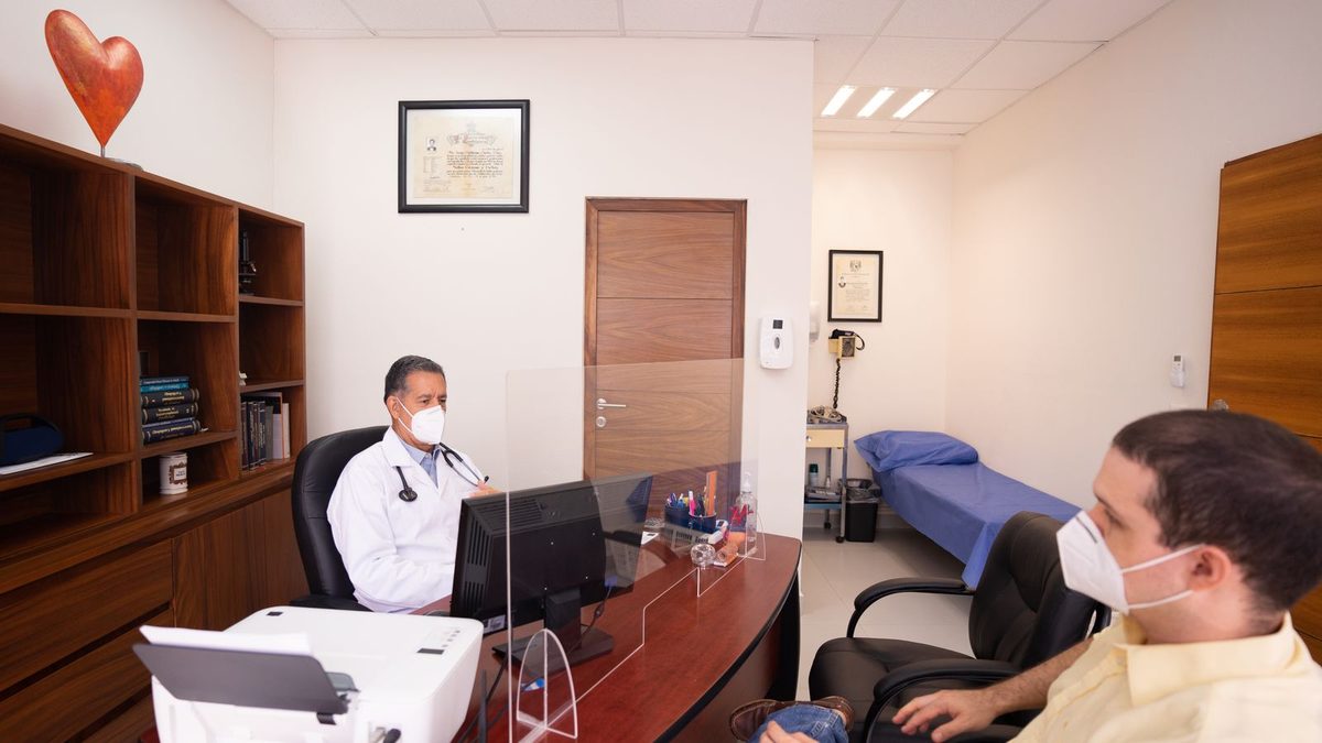 A doctor consulting with a patient in a clinical setting