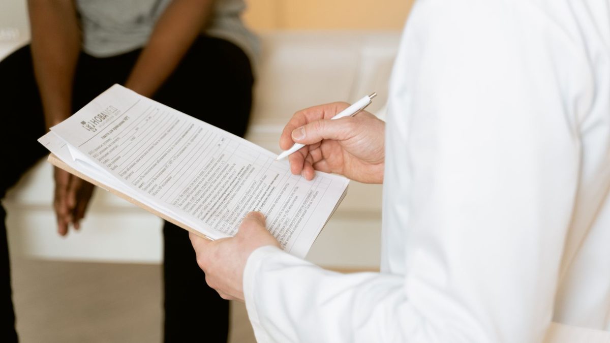 A doctor consulting with a patient in a clinical setting