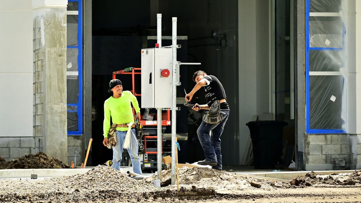 Construction and trade workers in safety gear on a job site