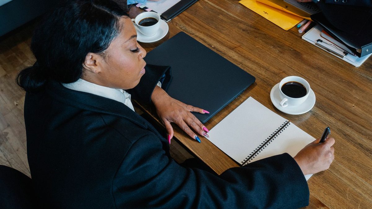 A diverse team of professionals discussing employee health benefits in a modern office