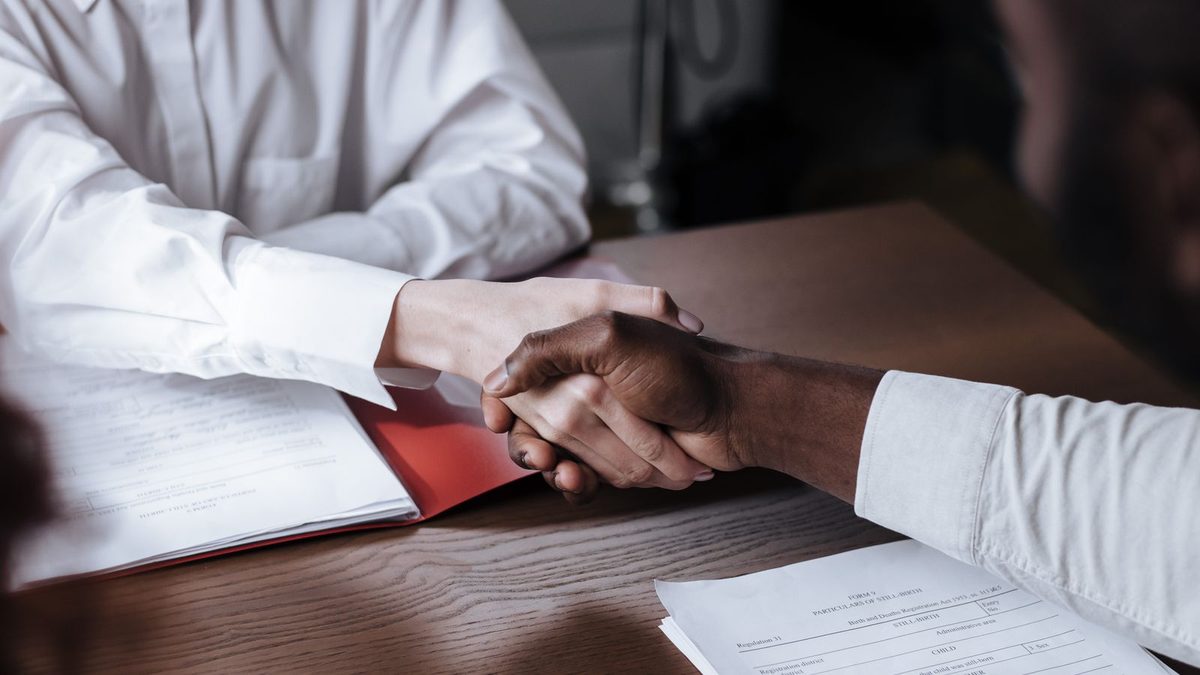 A diverse team of professionals discussing employee health benefits in a modern office