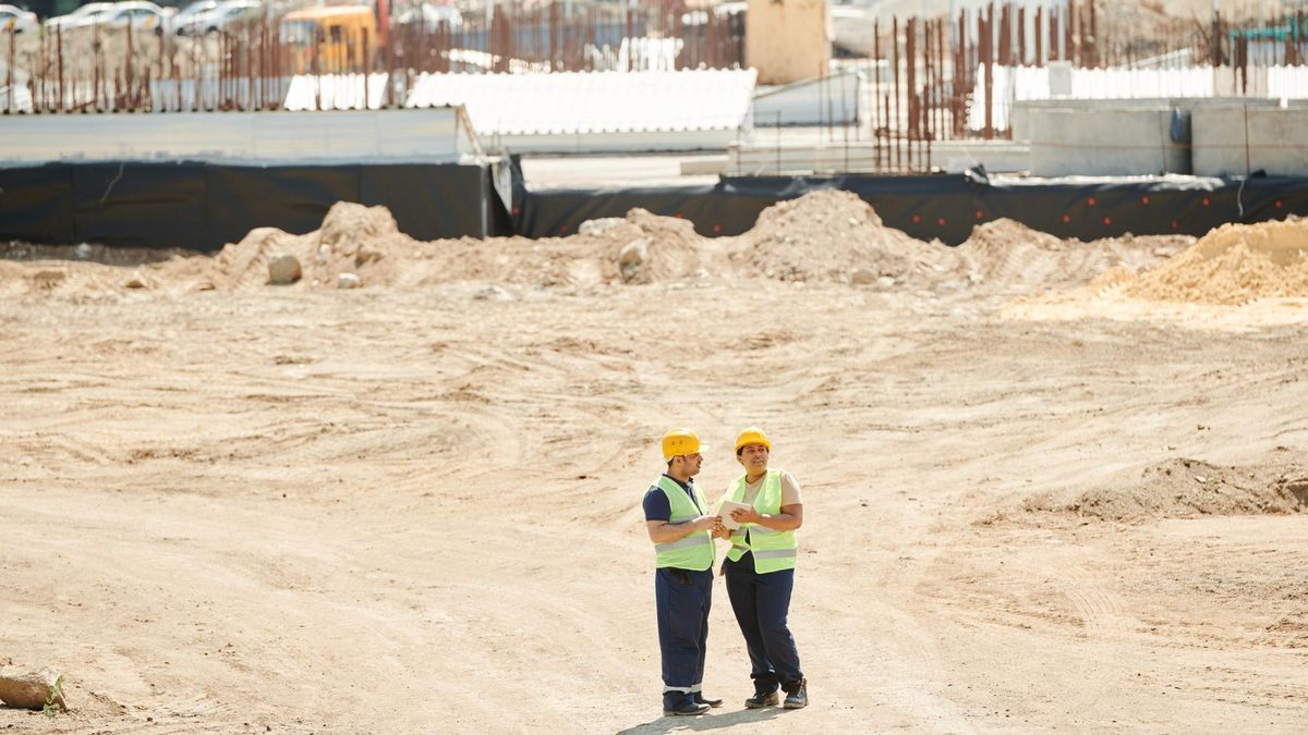 Construction and trade workers in safety gear on a job site