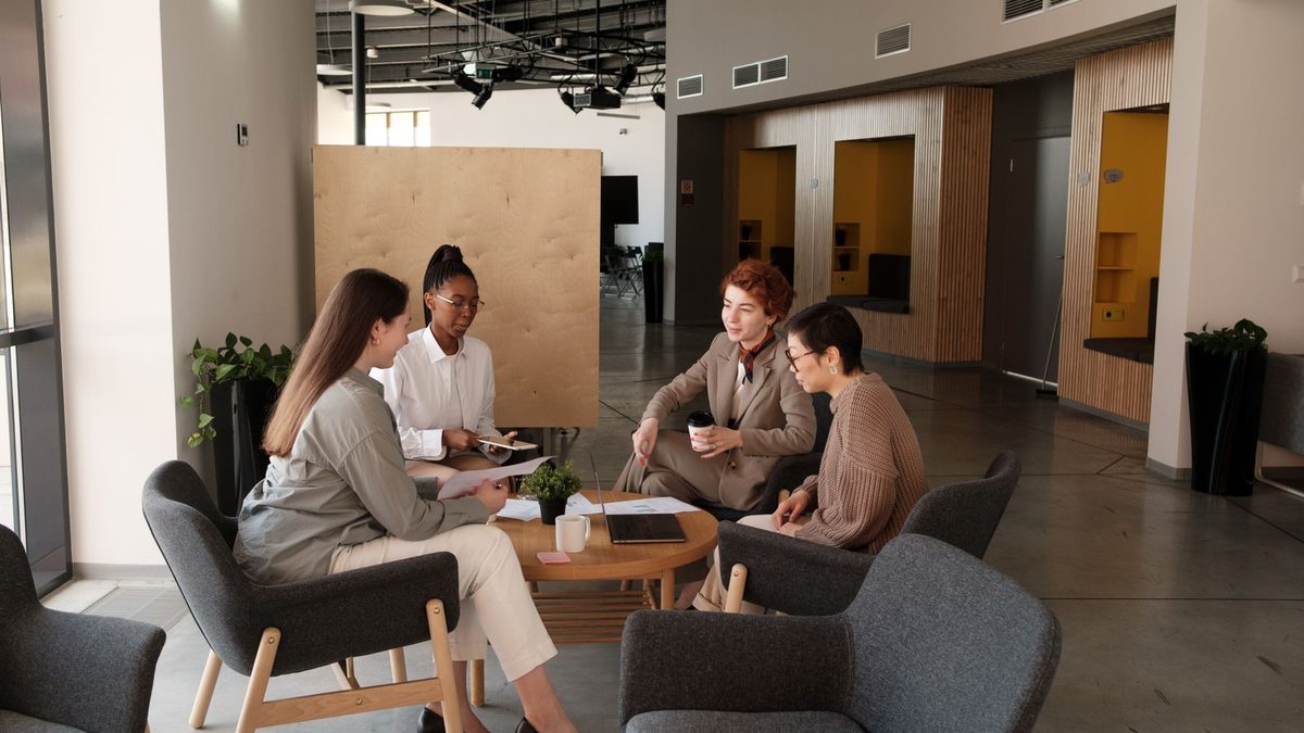 A diverse team of professionals discussing employee health benefits in a modern office