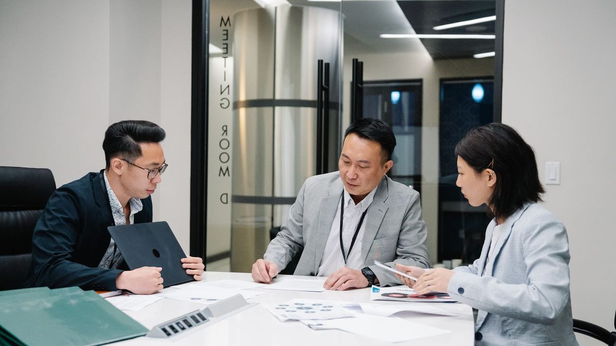 A diverse team of professionals discussing employee health benefits in a modern office