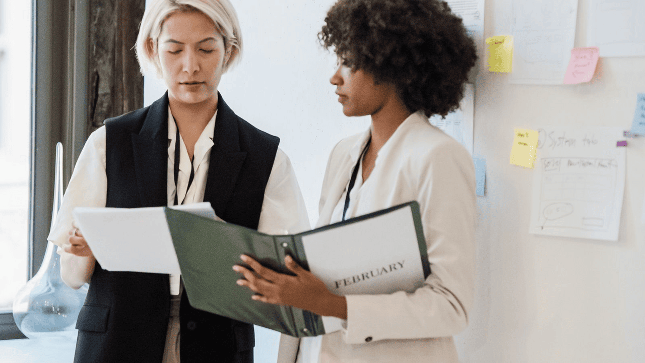 Mid-market employer comparing a PEO proposal and an ASO proposal at a desk