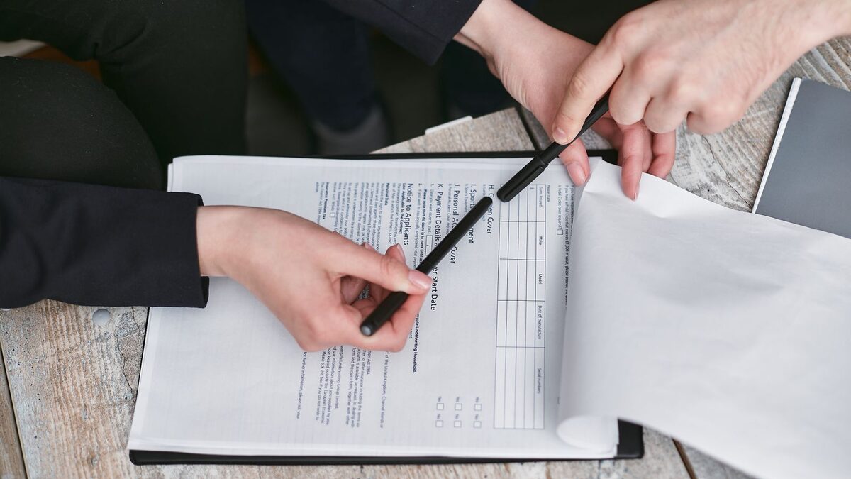 Employer and PEO representative reviewing a co-employment service agreement