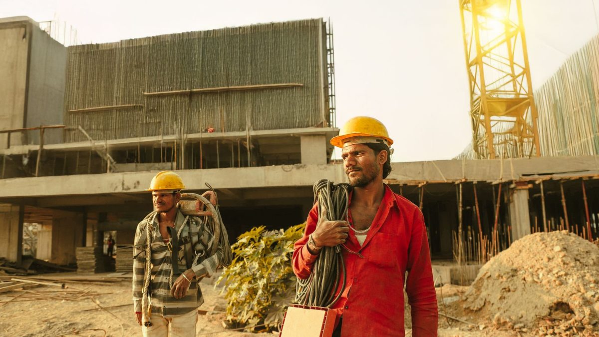 Construction and trade workers in safety gear on a job site