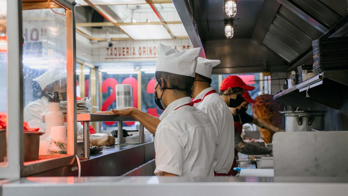 Restaurant and hospitality staff working together in a busy kitchen