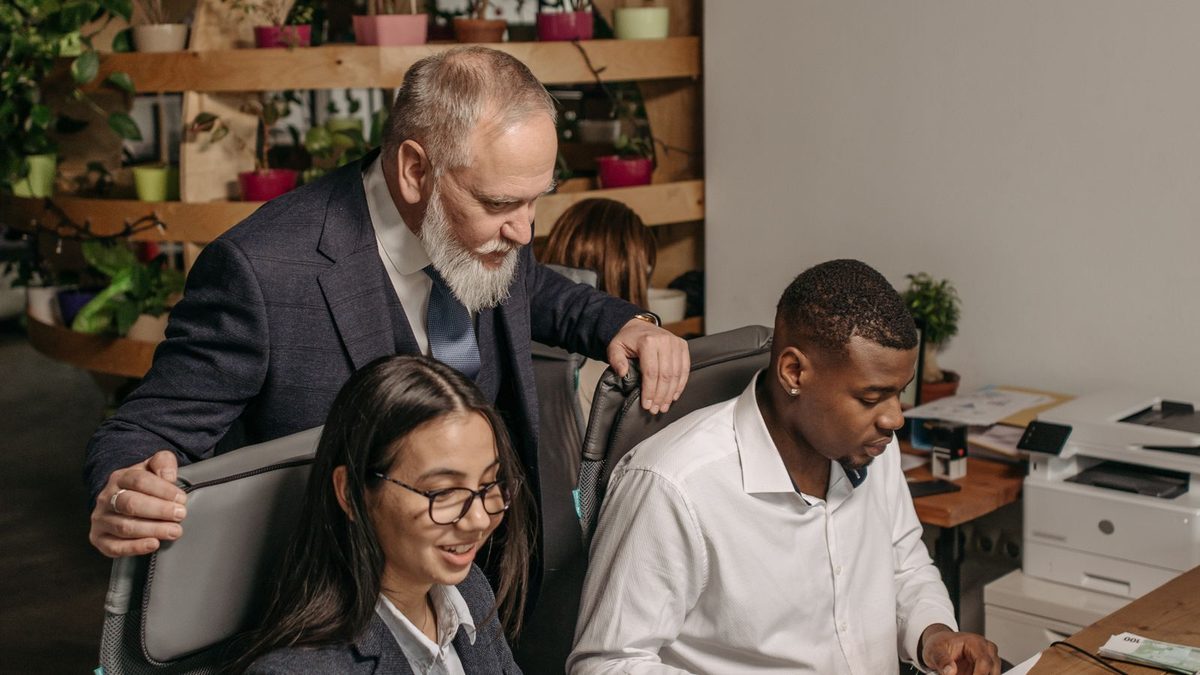 A diverse team of professionals discussing employee health benefits in a modern office
