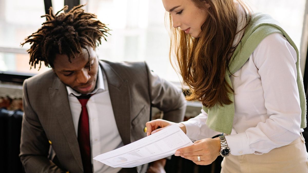 A diverse team of professionals discussing employee health benefits in a modern office