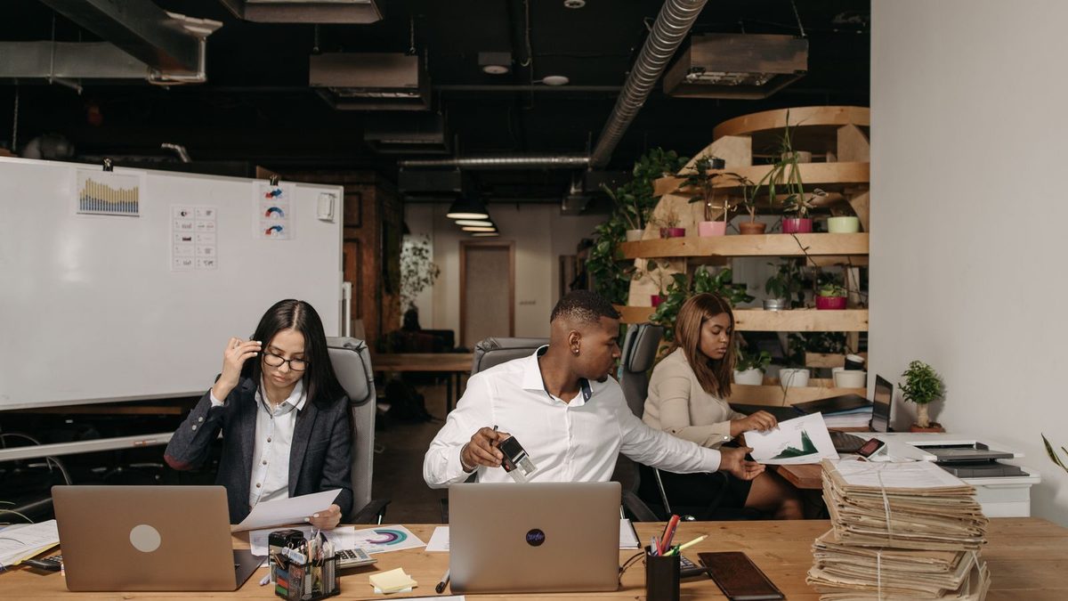 A diverse team of professionals discussing employee health benefits in a modern office