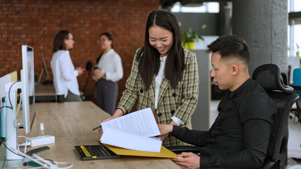 A diverse team of professionals discussing employee health benefits in a modern office