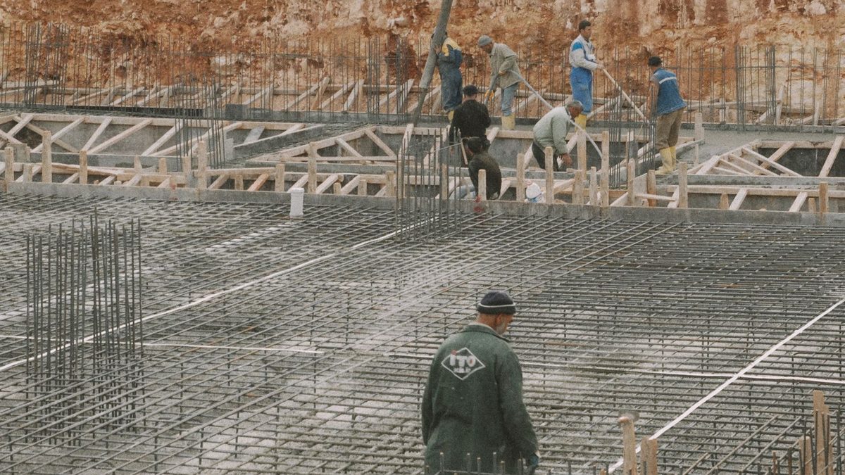 Construction and trade workers in safety gear on a job site