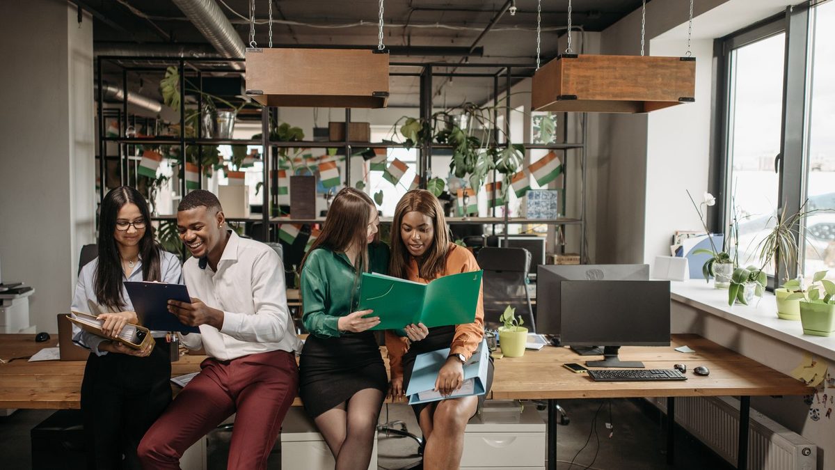 A diverse team of professionals discussing employee health benefits in a modern office