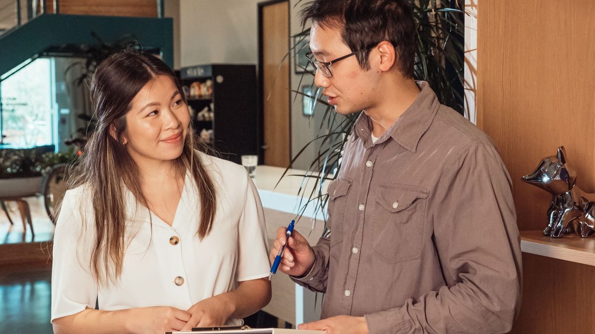 A diverse team of professionals discussing employee health benefits in a modern office