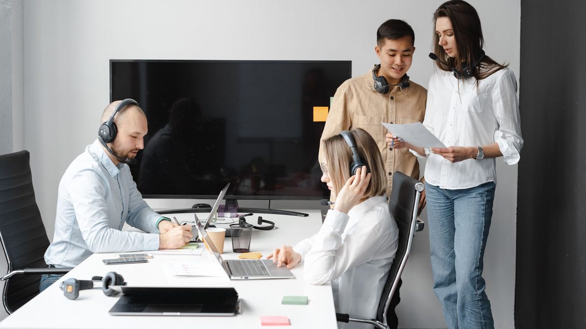 A diverse team of professionals discussing employee health benefits in a modern office