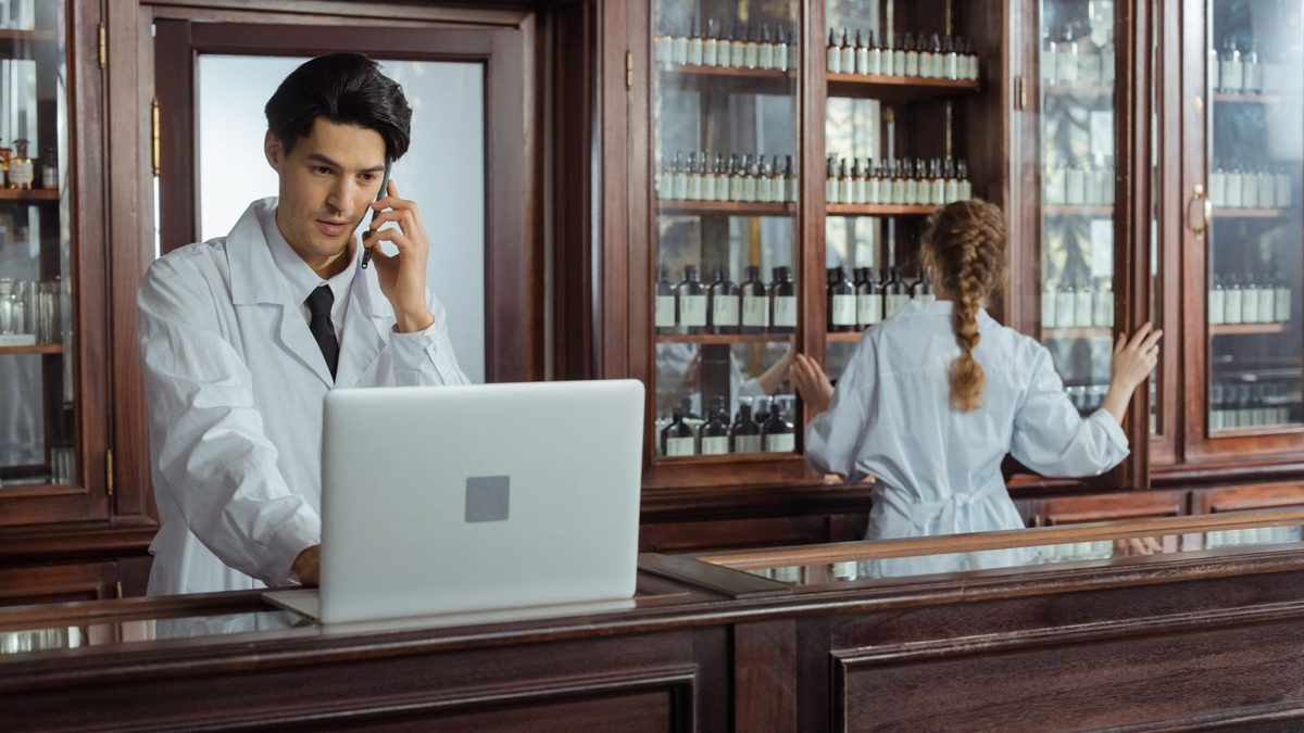 A pharmacist managing prescription medications in a pharmacy