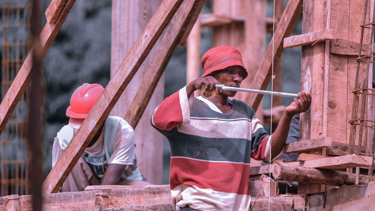 Construction and trade workers in safety gear on a job site